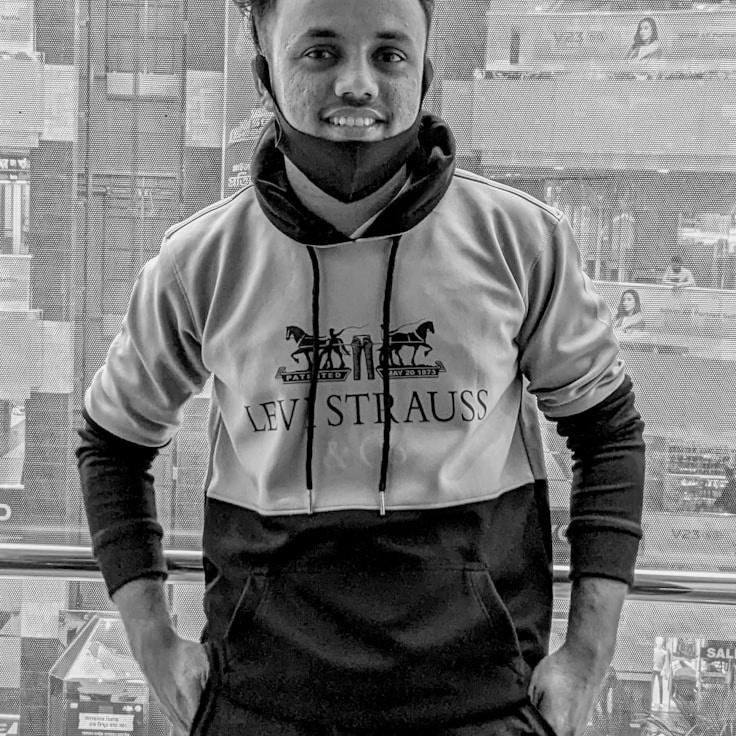 Kaveri Mehta, Lead Design Curator at East Stone Group, reviewing corporate floral arrangements